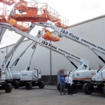 Derek Pierce of J&D Pierce, right, receives his Genie booms from Shane Paver of APS, left 1