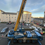 Sarens crane gives heat pump innovation a huge lift in Leith Sarens crane lift of heat pumps to Warmworks office roof