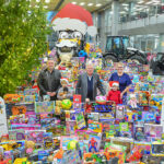 JCB Christmas Toy Appeal sets new record Adam Yates, Chief Operating Officer at the Hubb Foundation (left) and Rachael Holdcroft, NSPCC Strategic Services Manager, pictured with Lord Bamford and Rupert and Alice Chilman