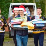 Olympic medallist helps wrap up JCB Christmas Toy Appeal Adam Burgess (centre) at the Hubb Foundation with JCB apprentices Ioan Evans, Laura Wilson, Harvey Napier and Muqadas Saleem