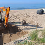 Develon mini helps prepare beach for busy summer season Excavator working in a beach