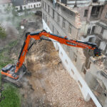Develon digger takes key role in demolition of ex-Tesla site Demolition excavator dismantling building