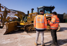 Rental business hails clean fuel delivery system Construction operatives in front of machinery