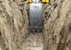 Industry hailed for new safe digging milestone Low level view of a backhoe bucket as it digs a trench