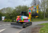 Distinctive digger set to raise vital funds for children’s charity Rainbow-coloured excavator on site
