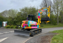 Distinctive digger set to raise vital funds for children’s charity Rainbow-coloured excavator on site