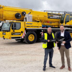 Growing crane firm snap up milestone five-axle all-terrain model Richard Foster (24/7 Crane Hire) and Lyle Sibbald (Liebherr Great Britain)