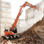 Tuff task: demolition excavator takes down historic building in Italy Building being demolished in Italy