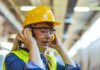 Plans unveiled for first construction-specific deaf awareness and hearing loss training programme A female worker wearing a safety helmet and earmuffs