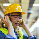 Plans unveiled for first construction-specific deaf awareness and hearing loss training programme A female worker wearing a safety helmet and earmuffs