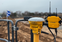 Construction tech specialist becomes member of SPOA SITECH technology on site with Scottish flag in background